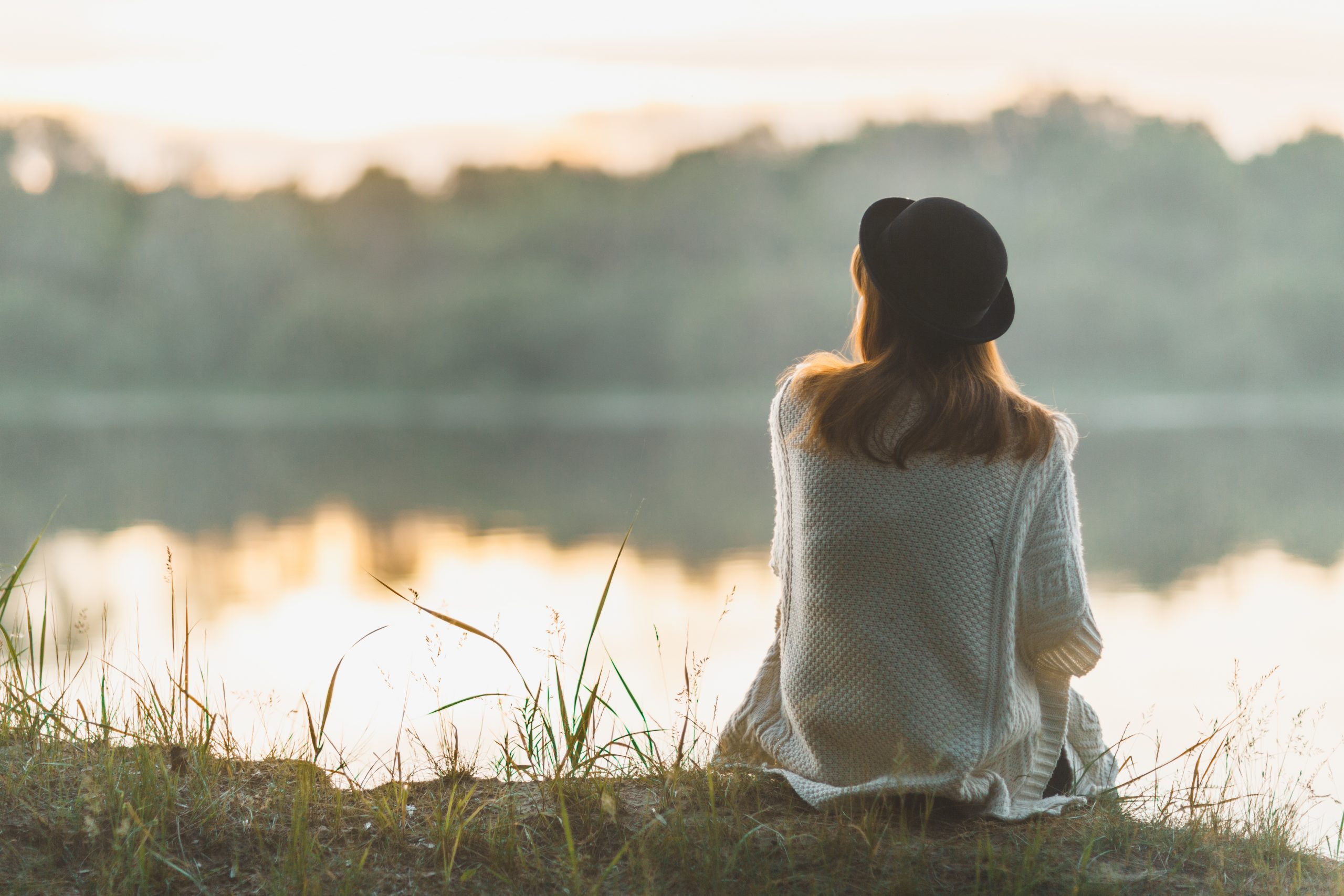 woman sat by a lake
